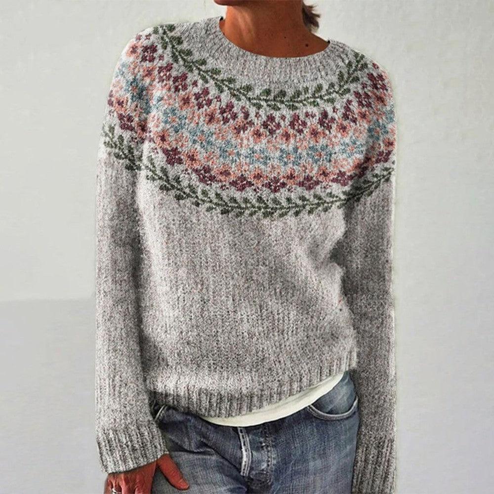 A woman wearing a round-neck sweater with a colourful Nordic pattern, cosy for fall.