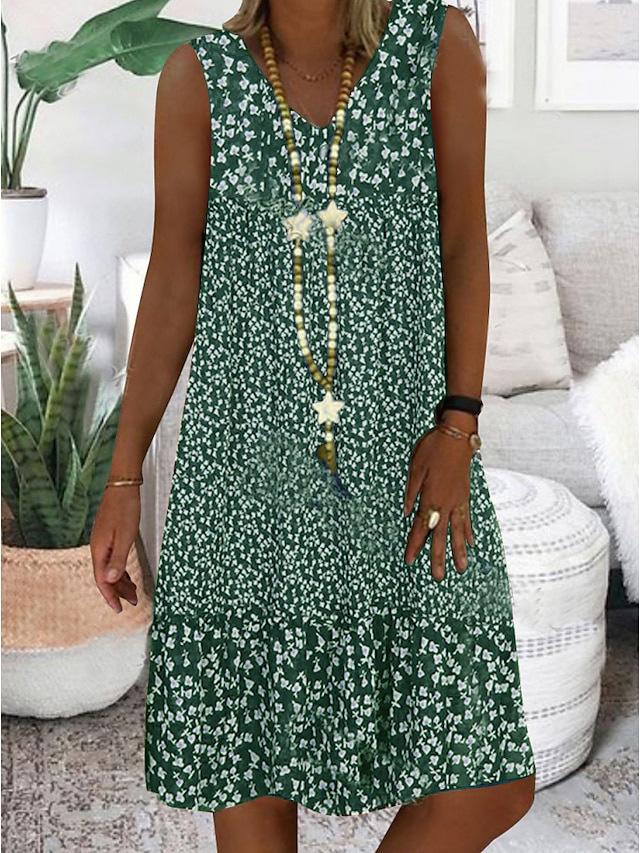 A woman wearing the Wendy sleeveless V-neck floral dress on a sunny day outdoors.