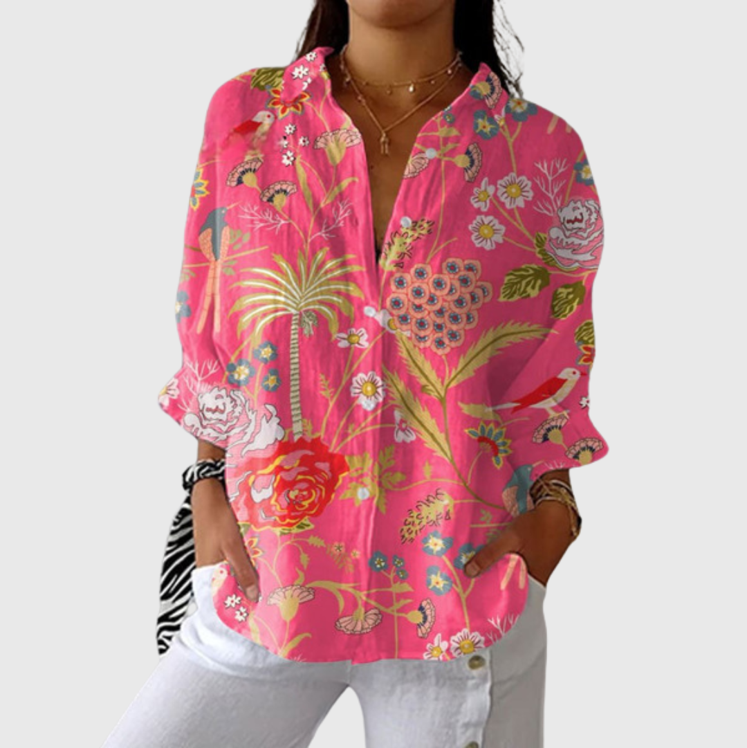 A woman wearing a flowing colourful printed blouse with an elegant button front, relaxed and comfortable on a day out.