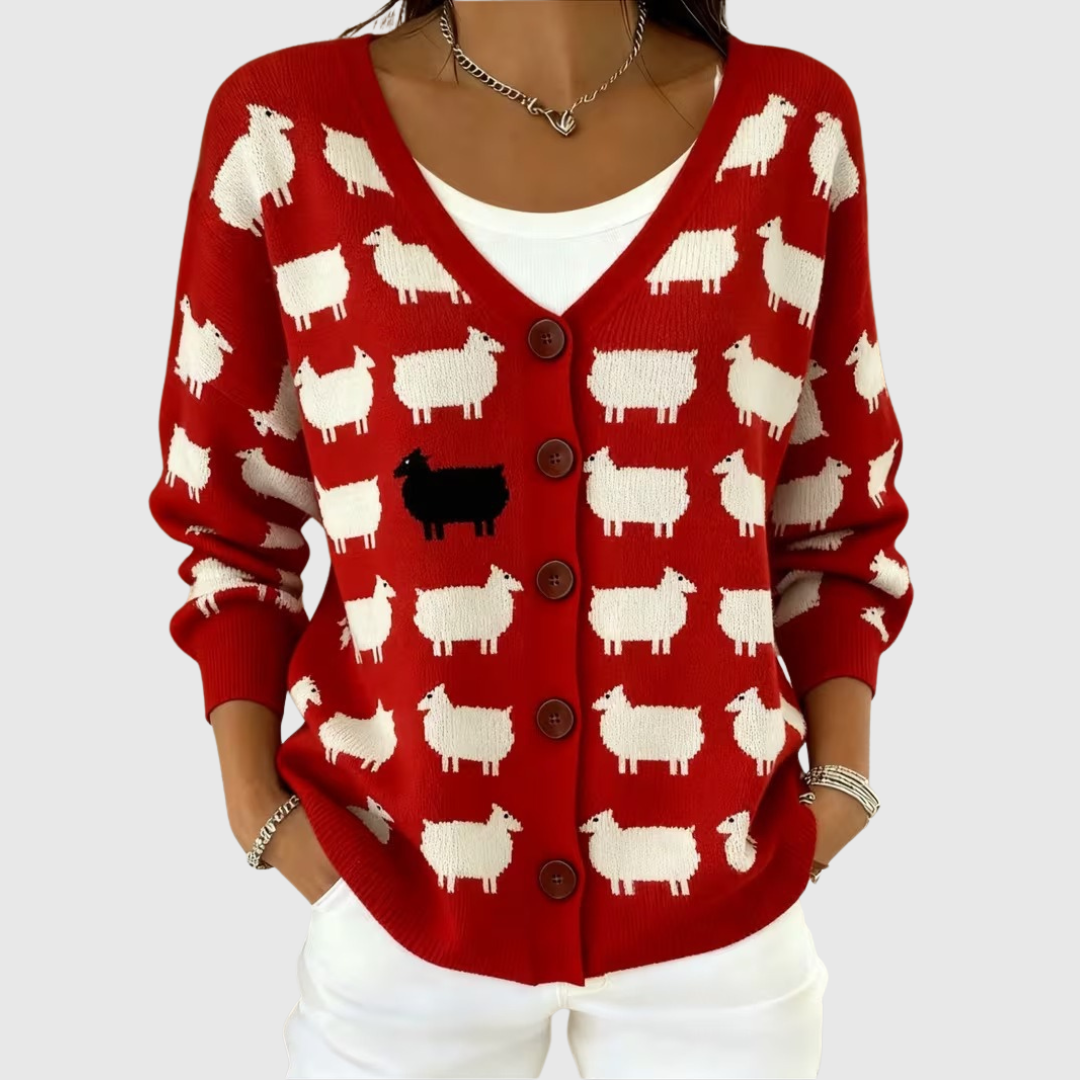A woman wearing a red buttoned cardigan patterned with cream sheep and one black sheep.