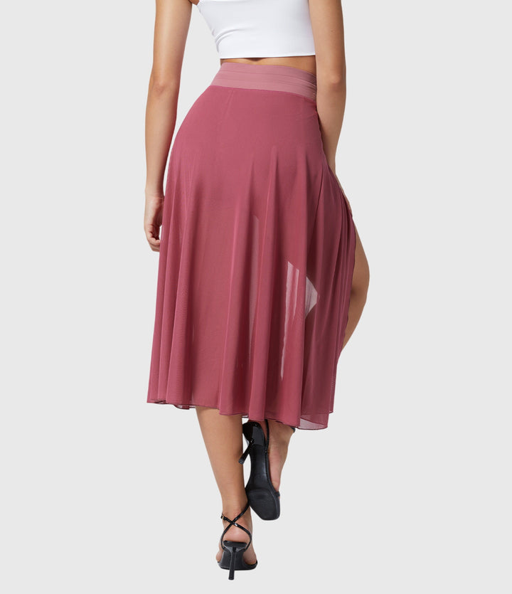 A woman in an elegant high-waisted flowing skirt, styled for a versatile day-to-evening look.