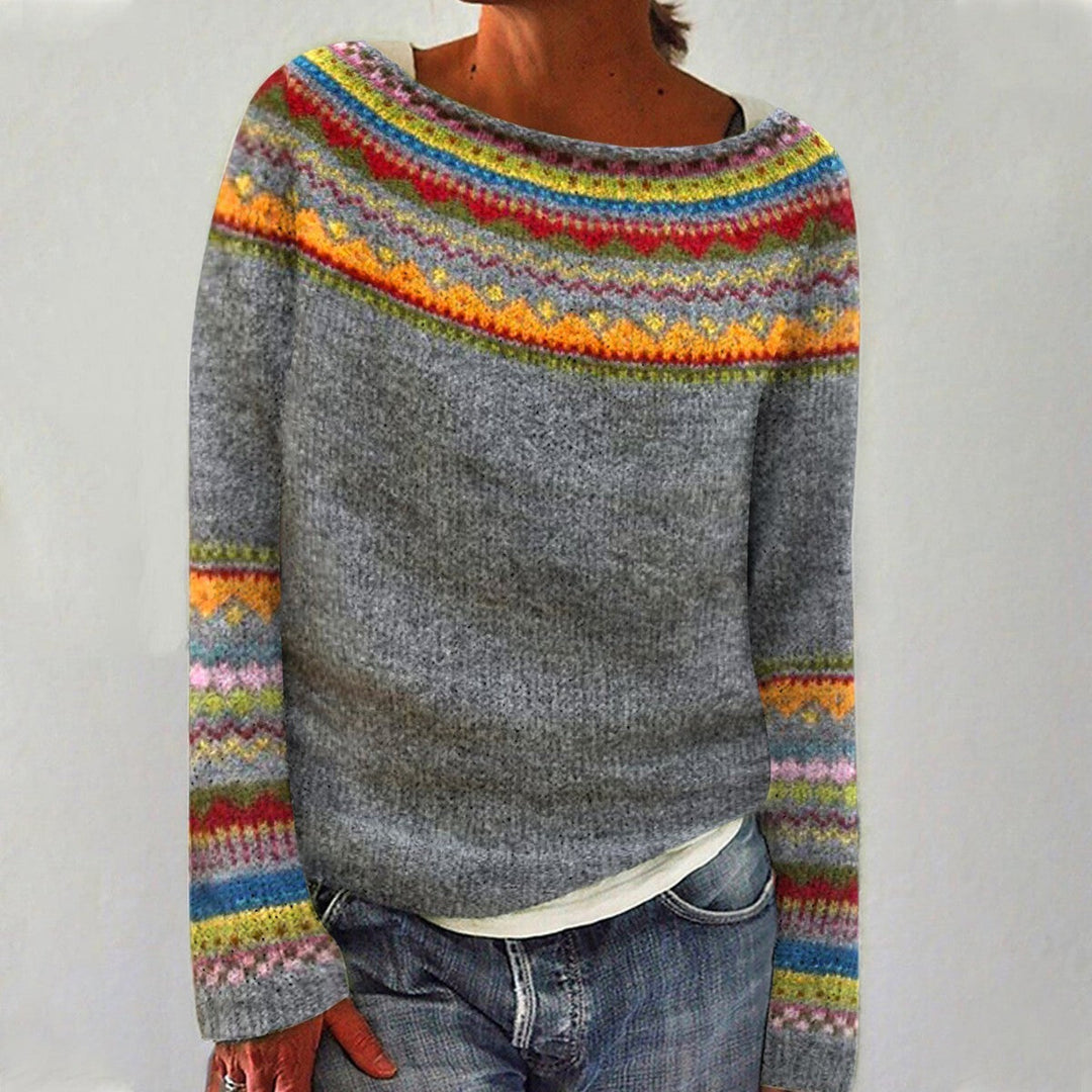 A woman wearing a retro sweater with a colourful Nordic pattern, cosy for fall.