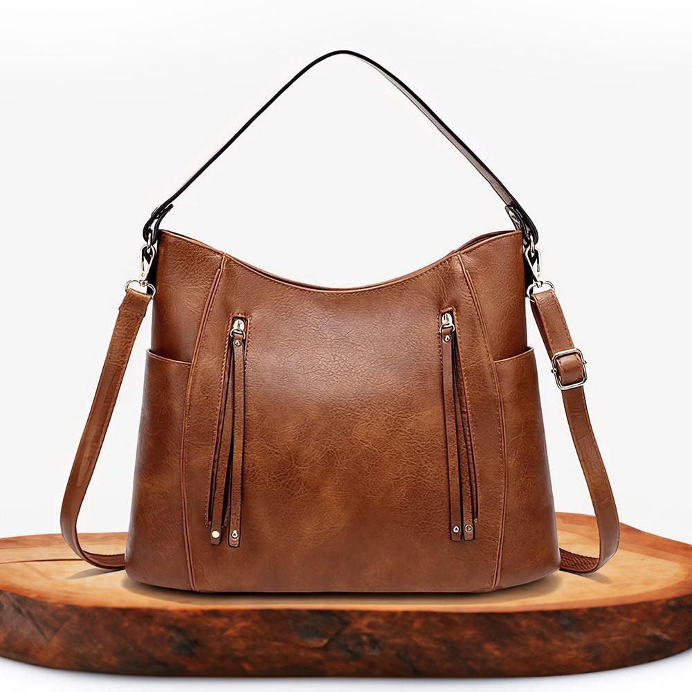 A woman carrying an elegant luxury shoulder bag with a rich finish