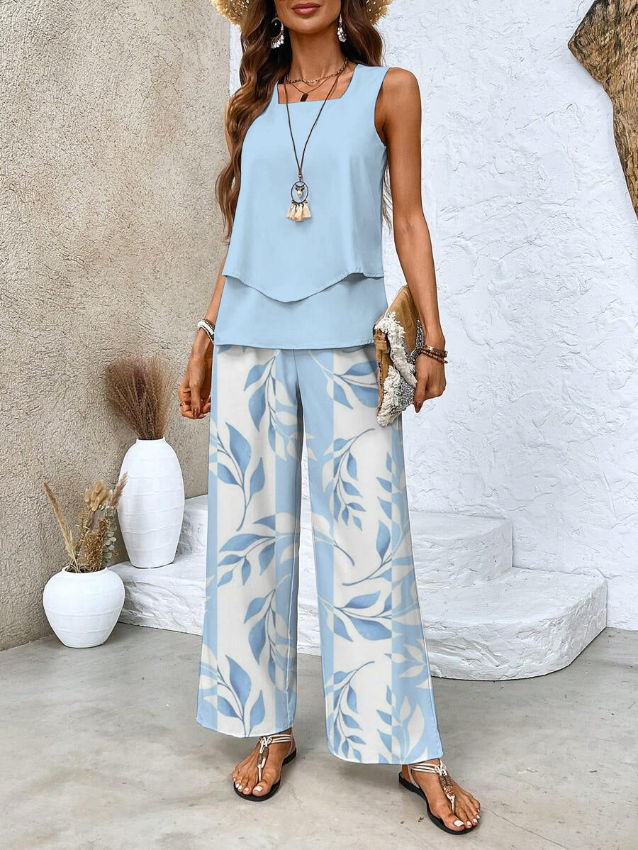 A woman wearing a layered sleeveless top with leaf-print wide-leg pants, light and elegant.