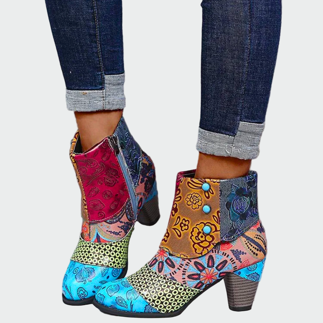 Woman wearing colourful boho-chic patterned boots with jeans on a bright day.