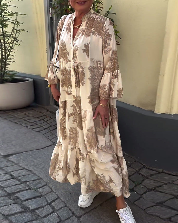 Woman wearing the Sylvie flowing maxi dress with a delicate print and V-neckline, the skirt moving softly as she walks.