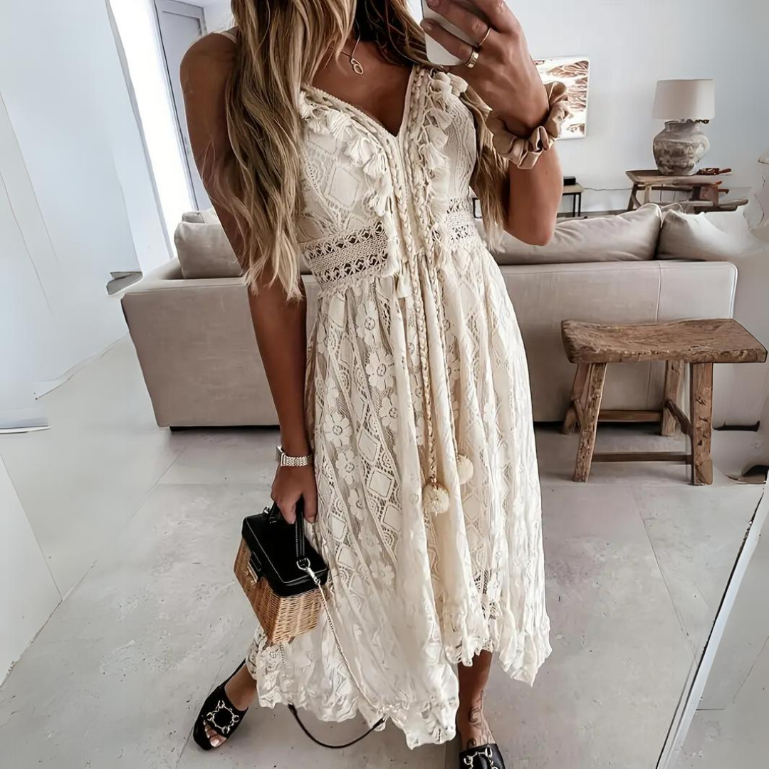 Woman wearing the Jill™ elegant boho midi dress with intricate detailing and a V-neckline at a summer garden party.