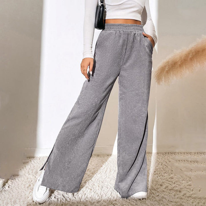 Woman wearing wide-leg ribbed joggers with a fitted top, relaxed at home.