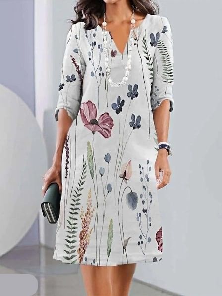 Woman wearing the Carolyn floral A-line dress in ivory, dressed for a daytime lunch.
