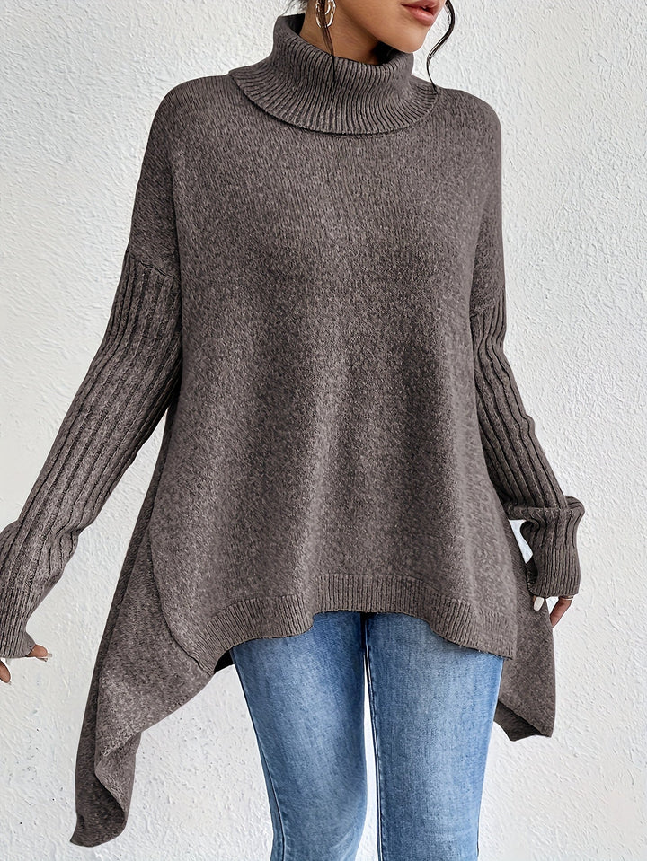 A woman wearing a stand-collar sweater with a chic asymmetric drape, warm and polished.