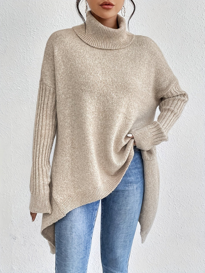 A woman wearing a stand-collar sweater with a chic asymmetric drape, warm and polished.