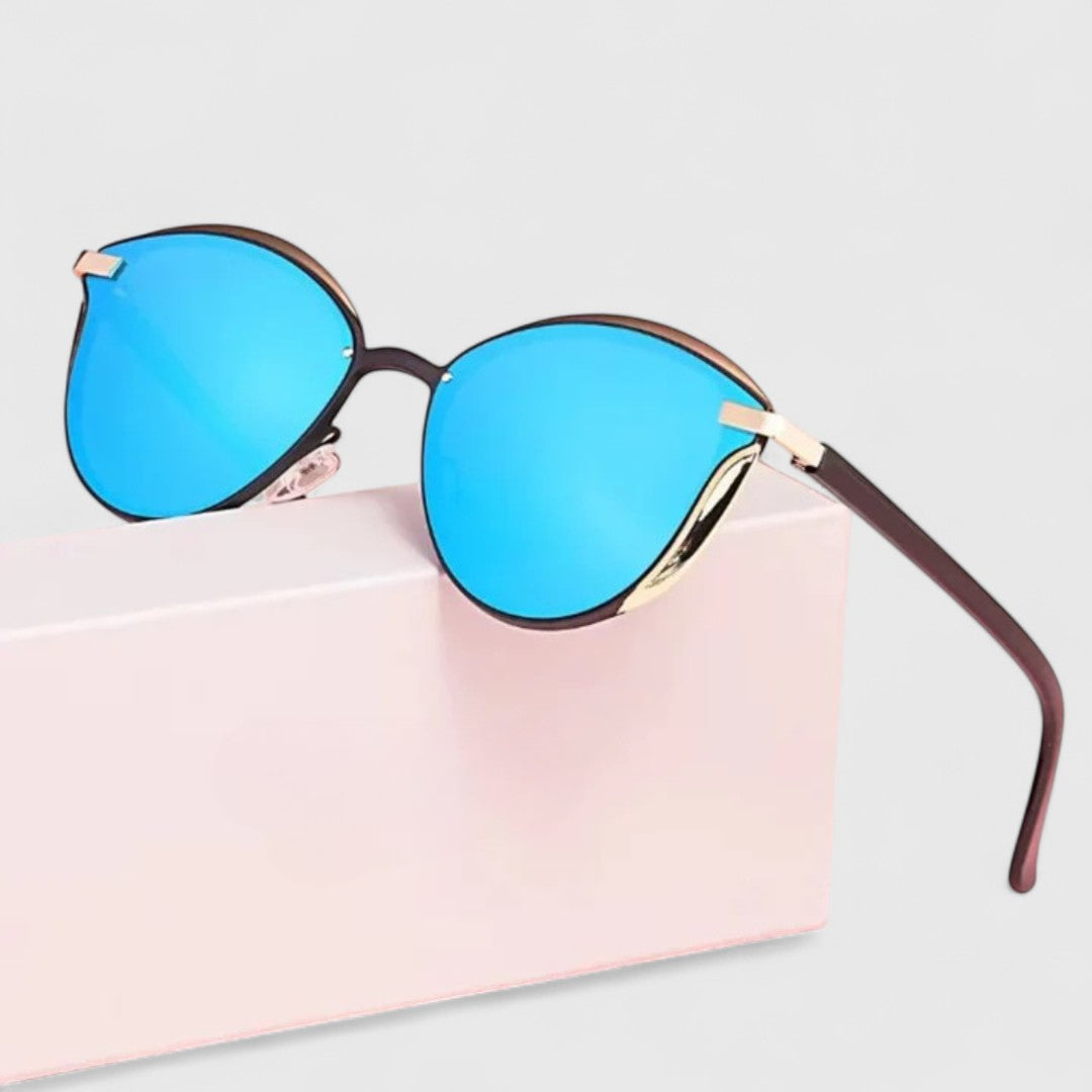 A woman wearing minimalist polarised gradient sunglasses on a bright day.