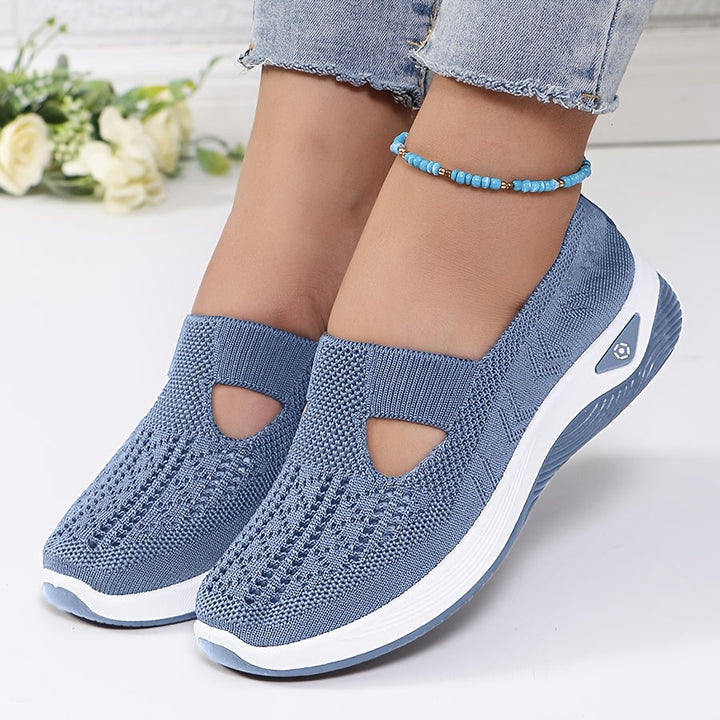 A woman stepping into easy slip-on comfort sneakers with no laces.