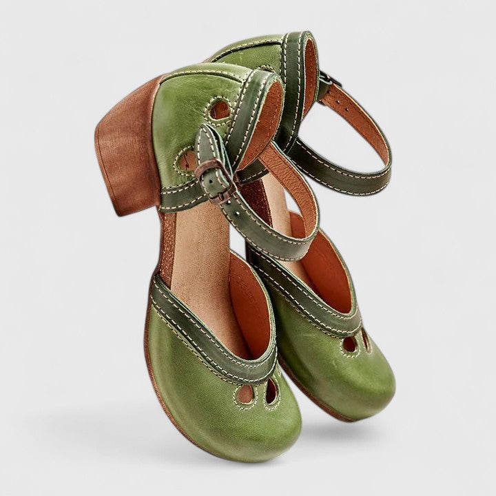 A woman in blue and green retro block heel shoes at a summer garden party.