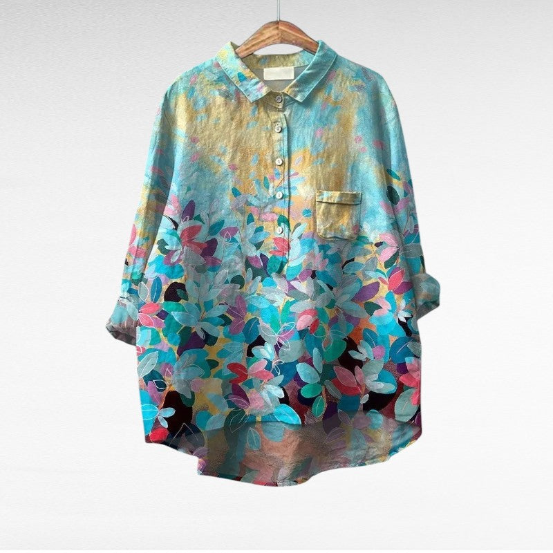 Woman wearing a flowing printed summer blouse with a graceful silhouette.