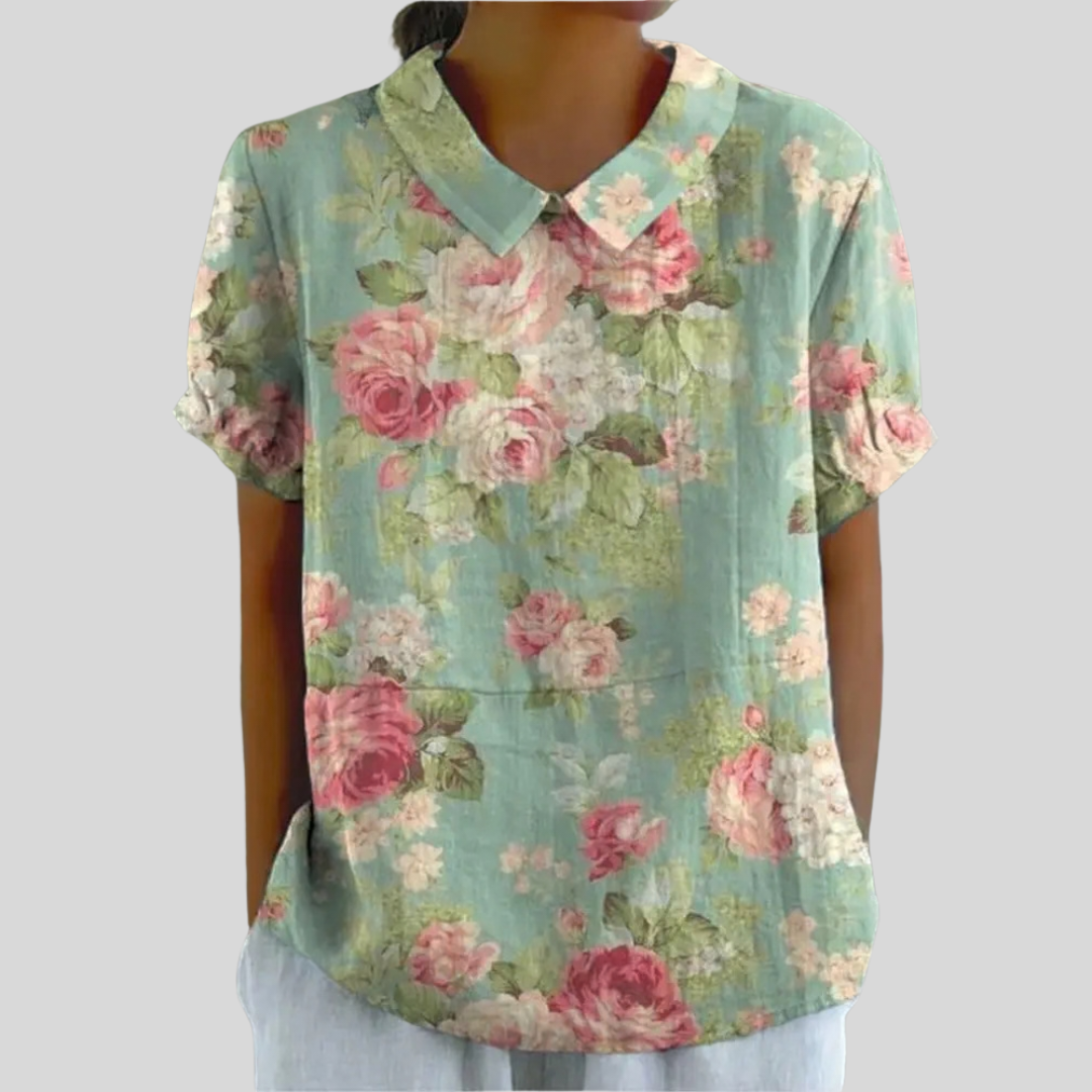 A woman wearing a floral top with a polo collar on a relaxed day