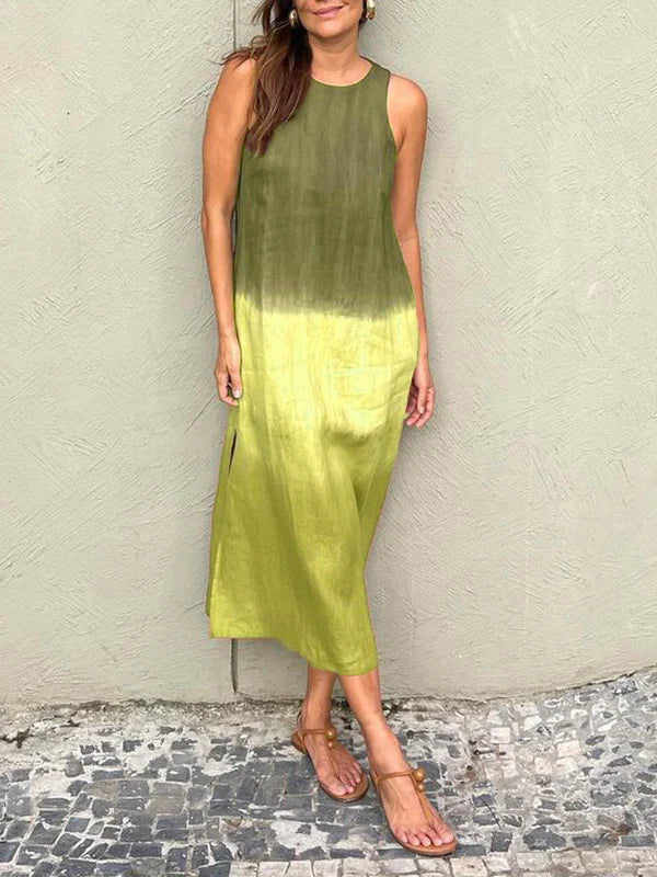 A woman wearing a sleeveless midi dress with a soft ombré colour gradient, walking outdoors.