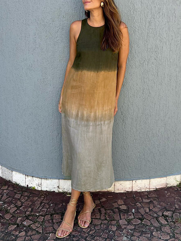 A woman wearing a sleeveless midi dress with a soft ombré colour gradient, walking outdoors.