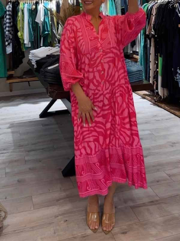 Woman wearing the Gina™ vivid printed maxi dress with a button front, standing confidently outdoors.
