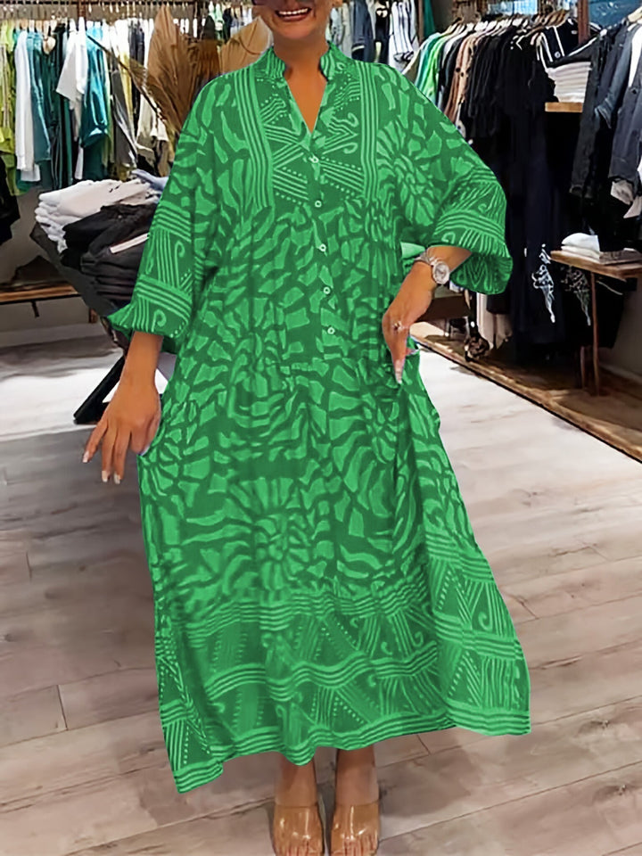 Woman wearing the Gina™ vivid printed maxi dress with a button front, standing confidently outdoors.
