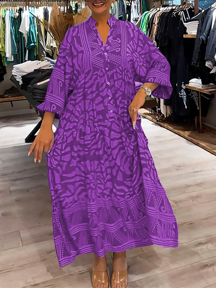 Woman wearing the Gina™ vivid printed maxi dress with a button front, standing confidently outdoors.