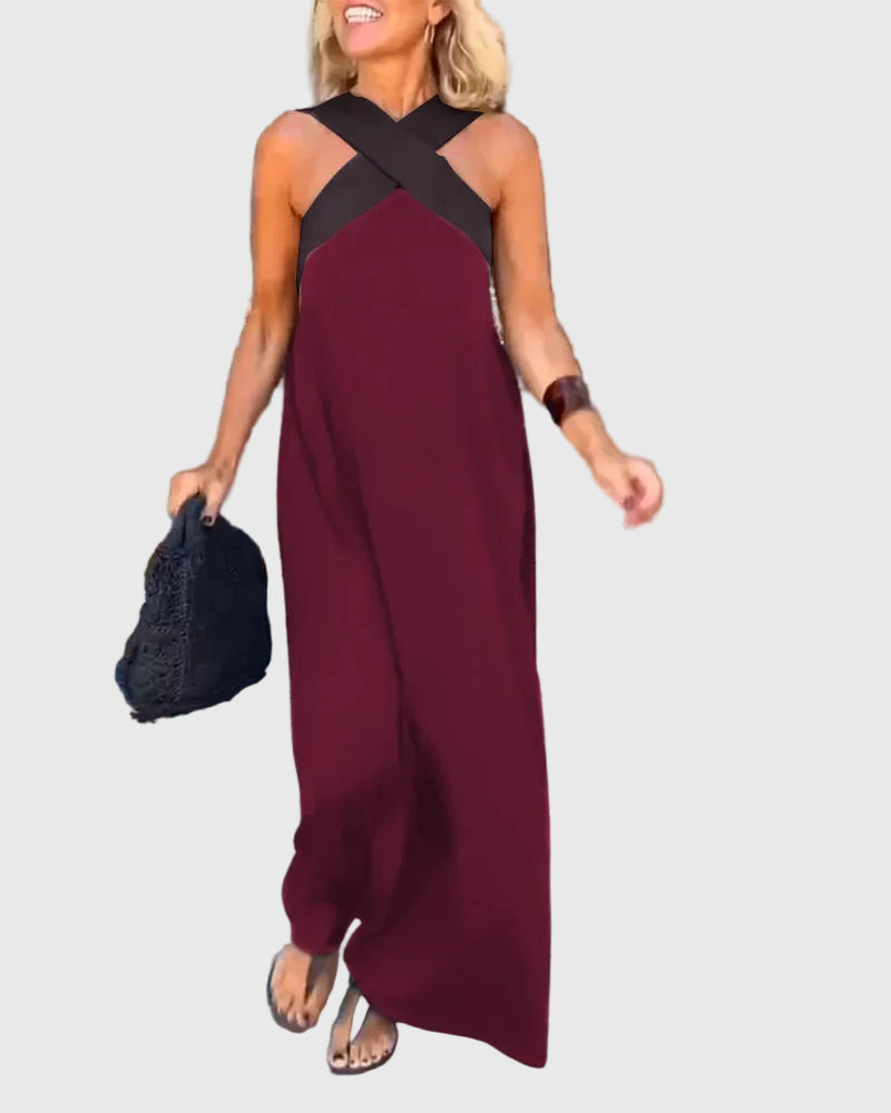 Woman wearing a long flowing maxi dress with a flattering crossover neckline.