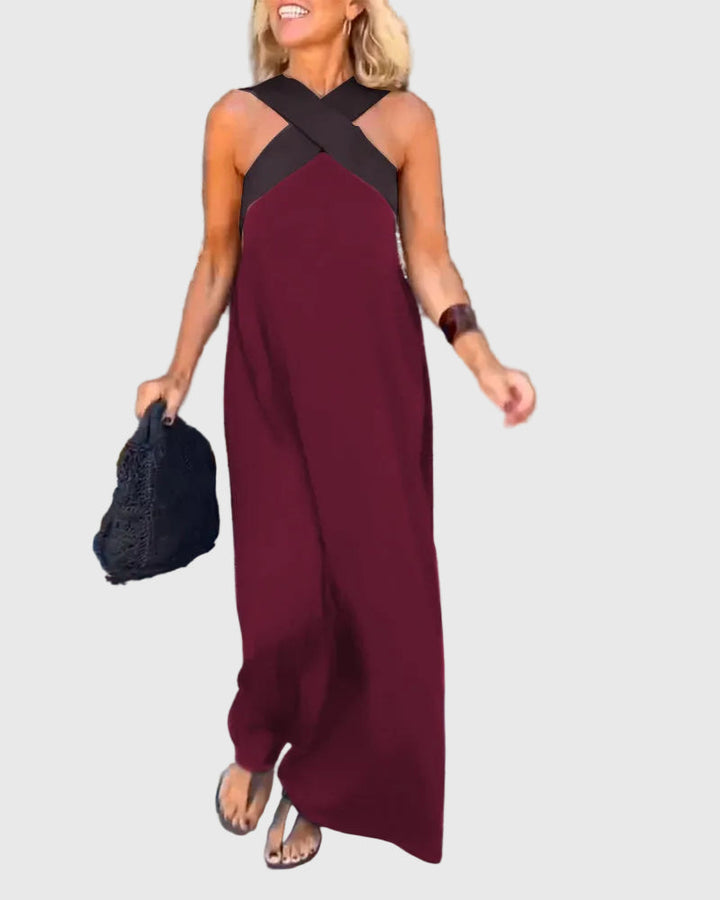 Woman wearing a long flowing maxi dress with a flattering crossover neckline.