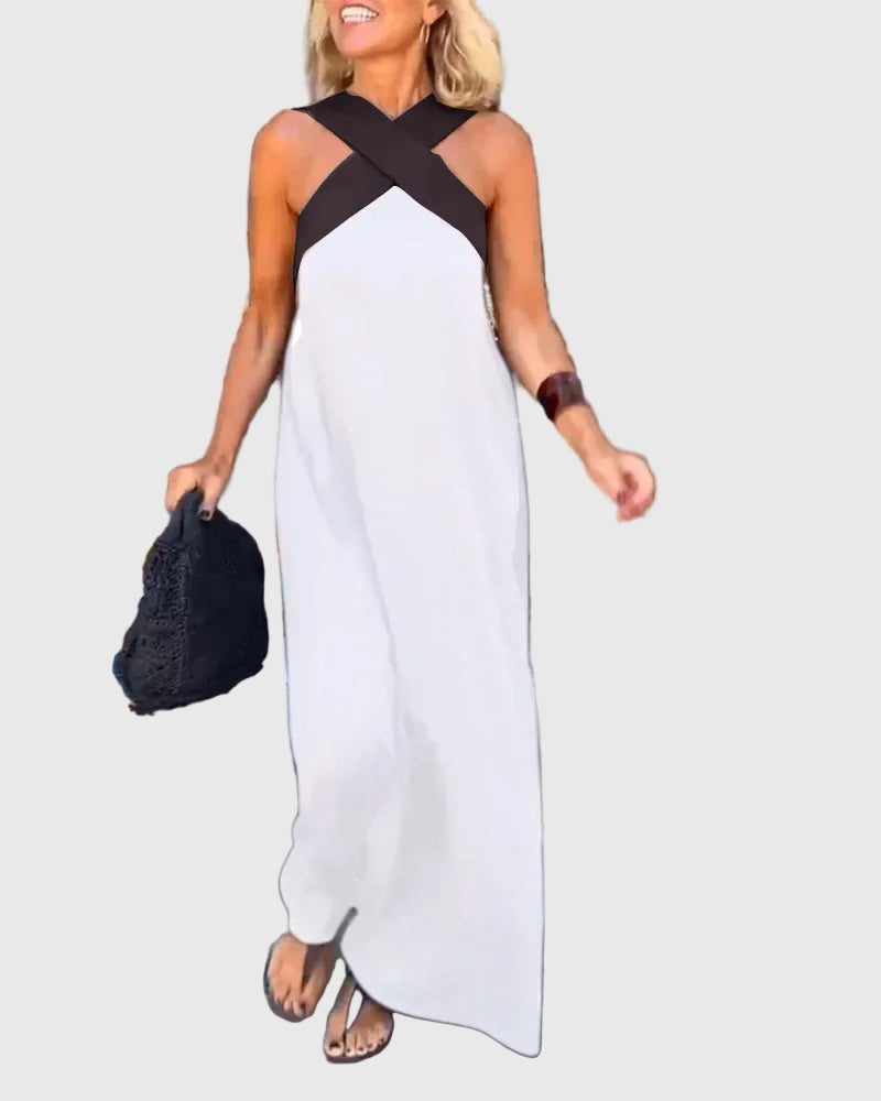 Woman wearing a long flowing maxi dress with a flattering crossover neckline.