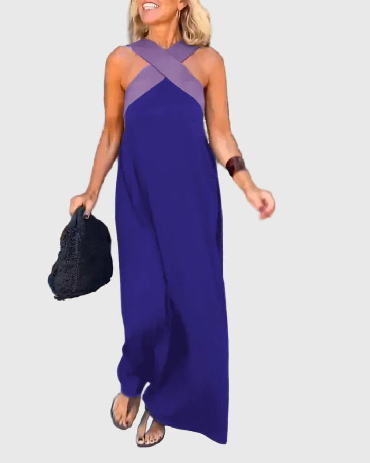Woman wearing a long flowing maxi dress with a flattering crossover neckline.