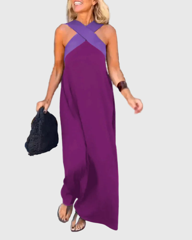 Woman wearing a long flowing maxi dress with a flattering crossover neckline.
