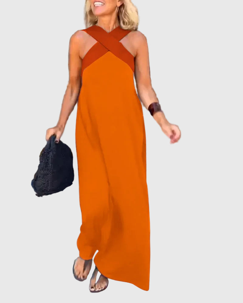 Woman wearing a long flowing maxi dress with a flattering crossover neckline.