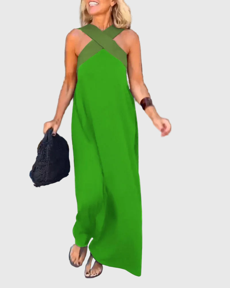 Woman wearing a long flowing maxi dress with a flattering crossover neckline.