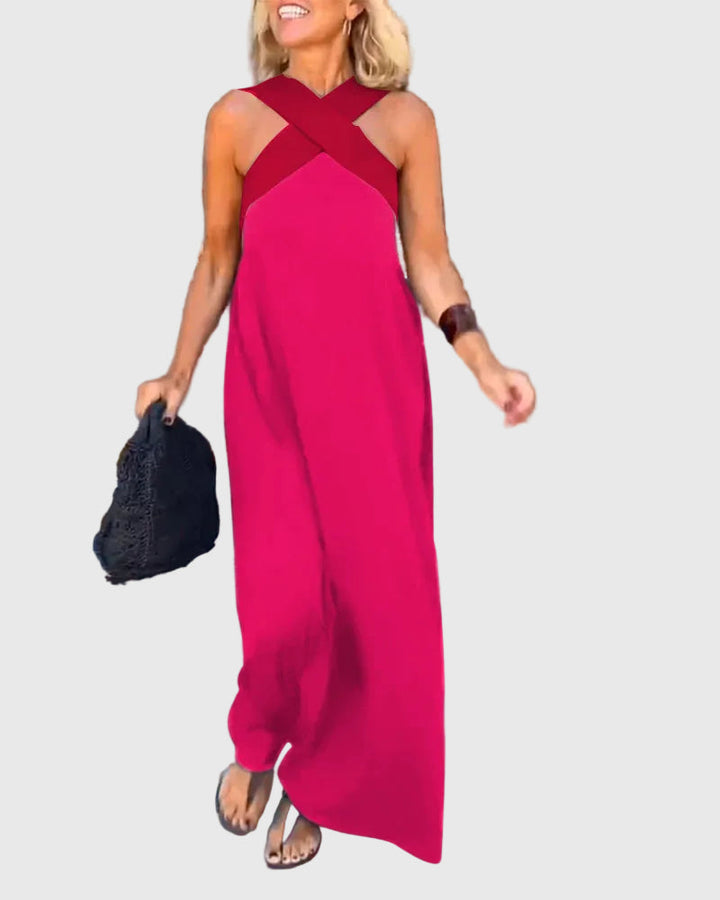 Woman wearing a long flowing maxi dress with a flattering crossover neckline.