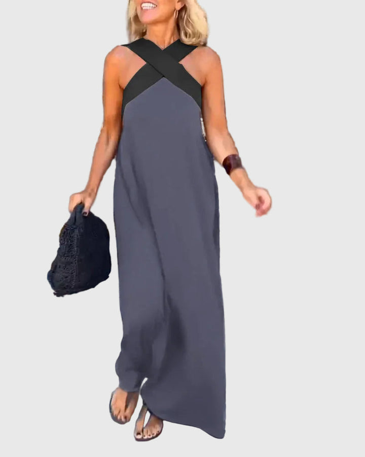 Woman wearing a long flowing maxi dress with a flattering crossover neckline.