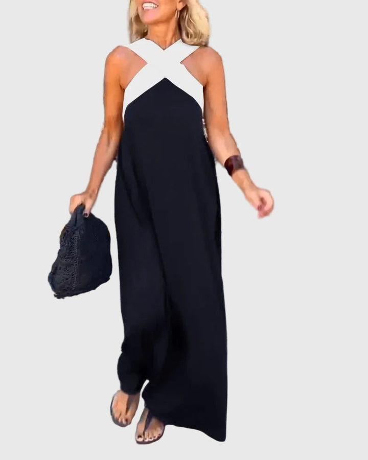 Woman wearing a long flowing maxi dress with a flattering crossover neckline.
