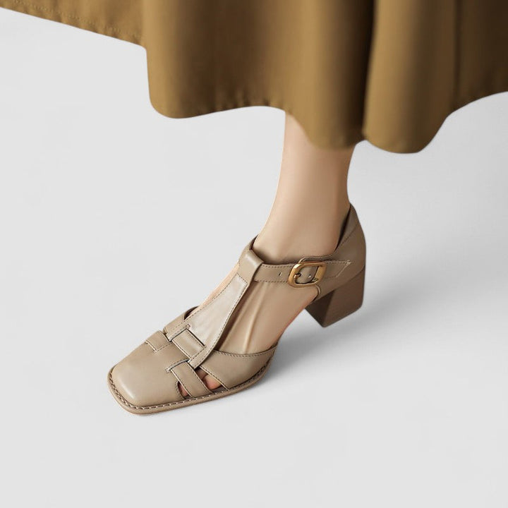 A woman in brown T-strap block heel shoes with a square toe, steady and comfortable during a day out.