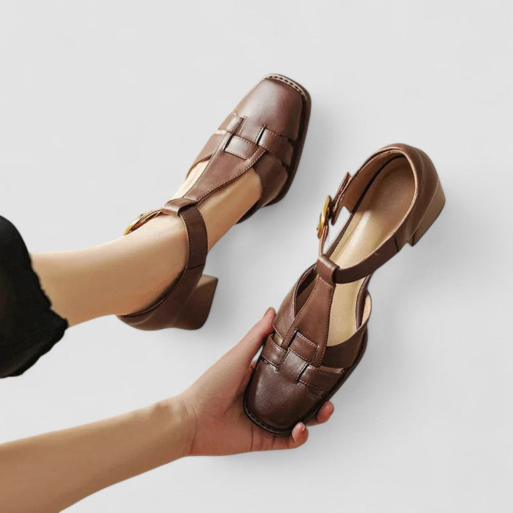 A woman in brown T-strap block heel shoes with a square toe, steady and comfortable during a day out.