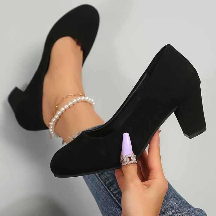 A woman in sturdy block heels standing comfortably and confidently through a long day.