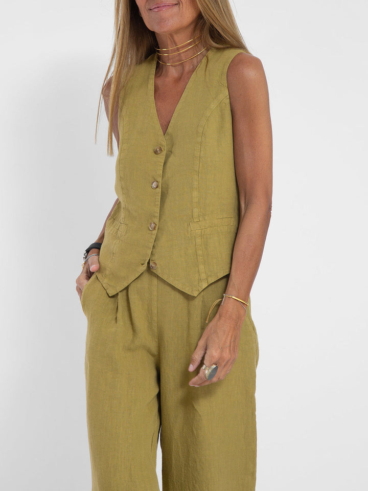 A woman wearing a tailored waistcoat with flowing wide-leg pants