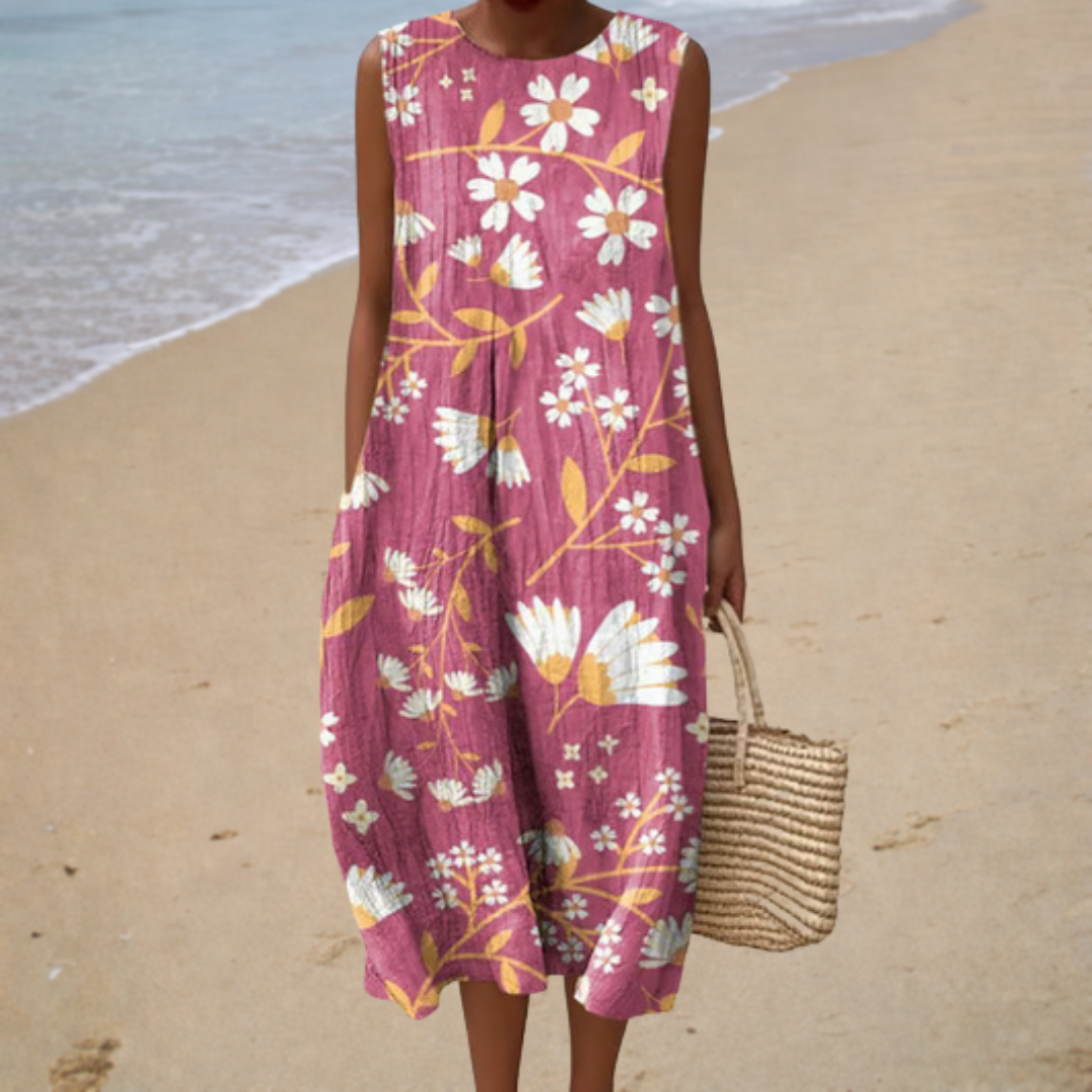 A woman wearing a loose sleeveless patterned summer dress, cool and polished on a warm day.