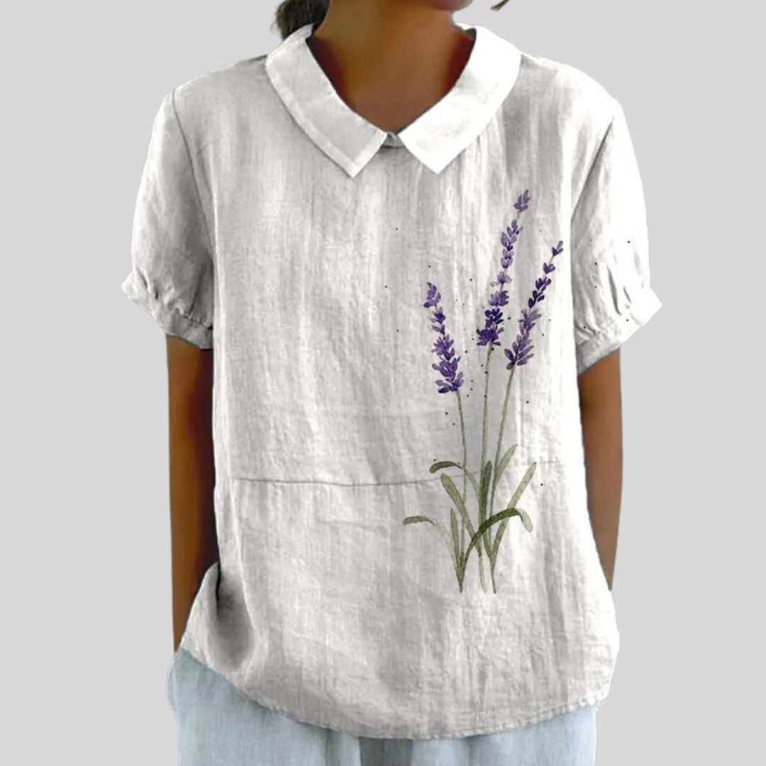 A woman wearing a floral top with a polo collar on a relaxed day