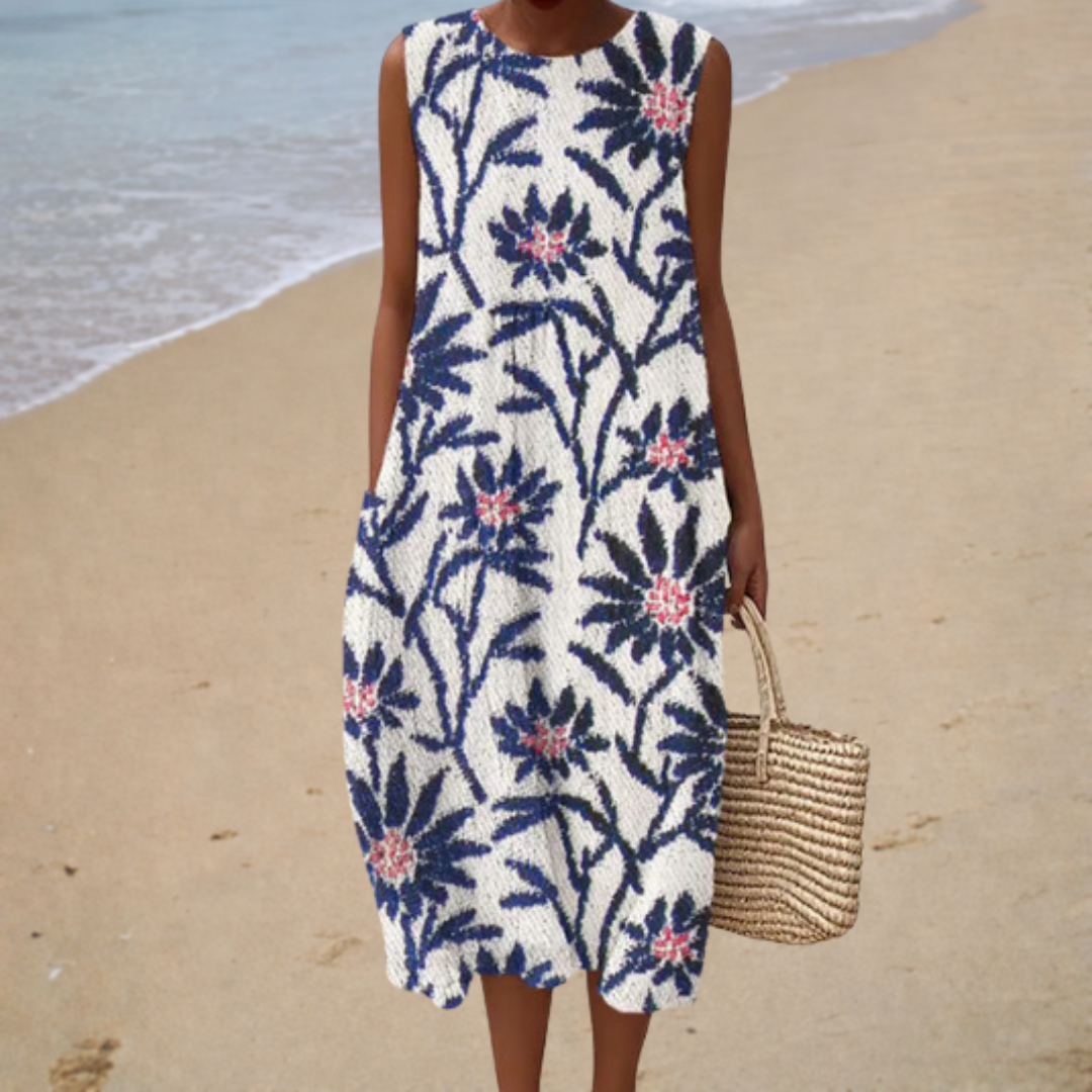 A woman wearing a loose sleeveless patterned summer dress, cool and relaxed on a hot day.