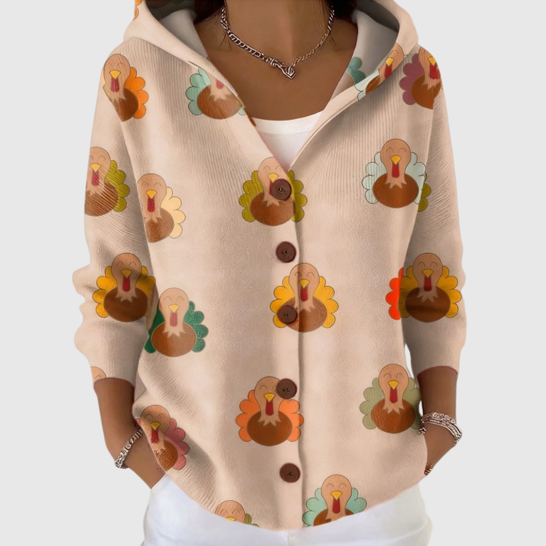 A woman wearing a soft everyday hooded cardigan open over a top on a mild day