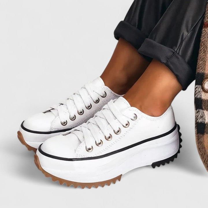 A woman in platform comfort sneakers giving a flattering little lift.