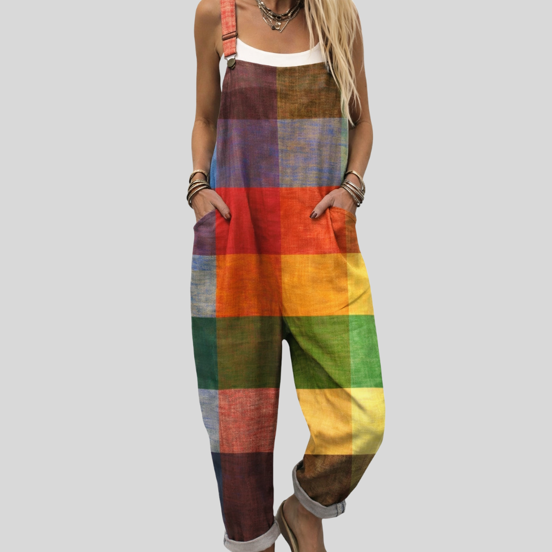Woman wearing bold overalls in a warm patchwork of orange, red, green and blue colour blocks.