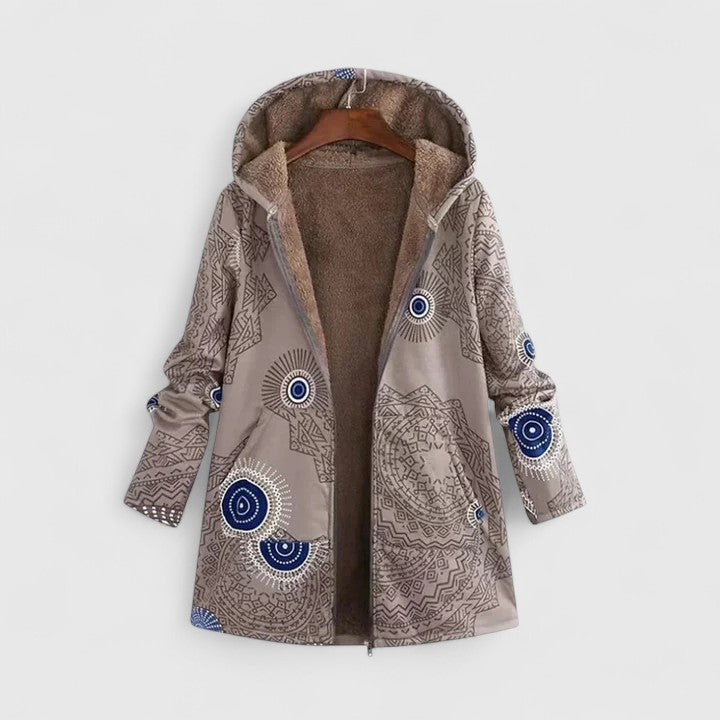 A woman wearing a geometric-print boho jacket, warmly layered on a winter day out.