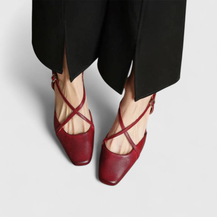 Burgundy closed square-toe flats with criss-cross instep straps and a buckled slingback.