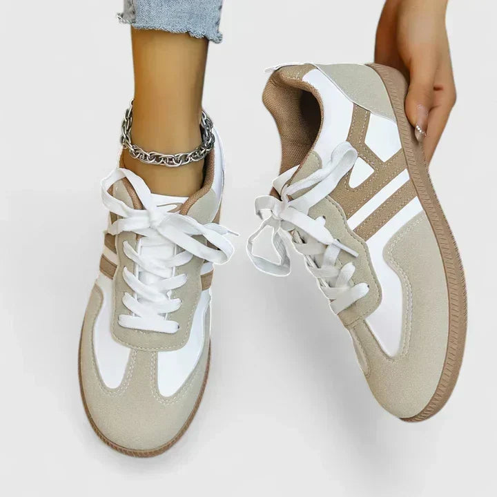 A woman wearing khaki and white orthopaedic sneakers on a relaxed walk.
