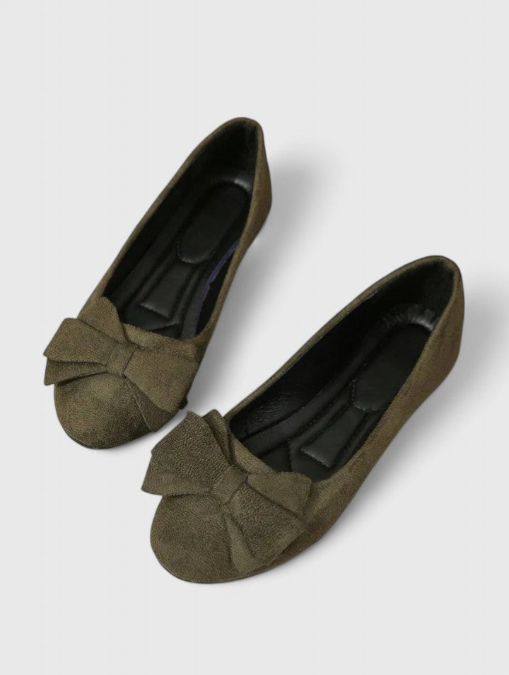 A pair of olive-green ballet flats with a soft bow at the rounded toe.