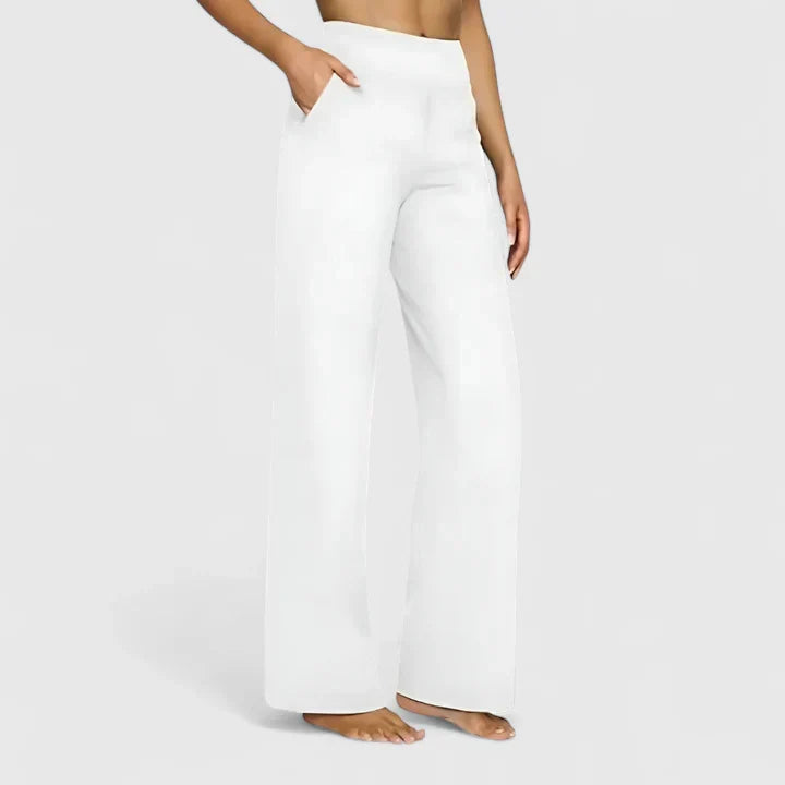 A woman in elegant straight-leg pants with pockets, styled for a polished everyday look.